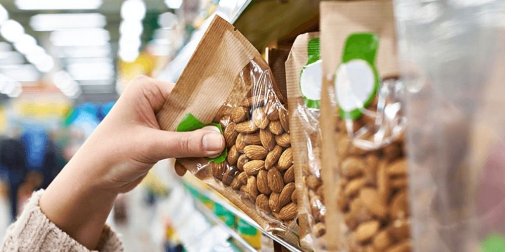 Hand reaching for a bag of almonds on a shelf