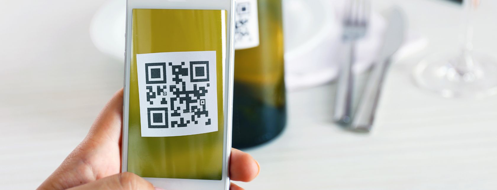 Woman scanning QR code with mobile phone