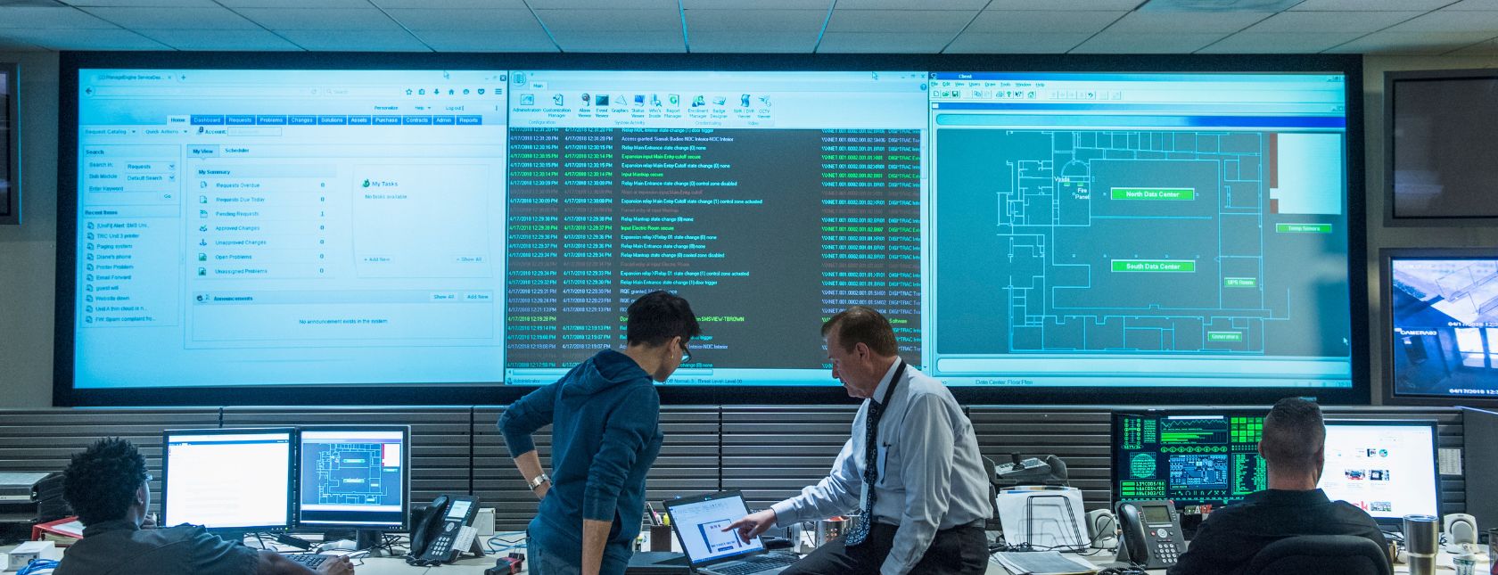 Colleagues working together in server control room